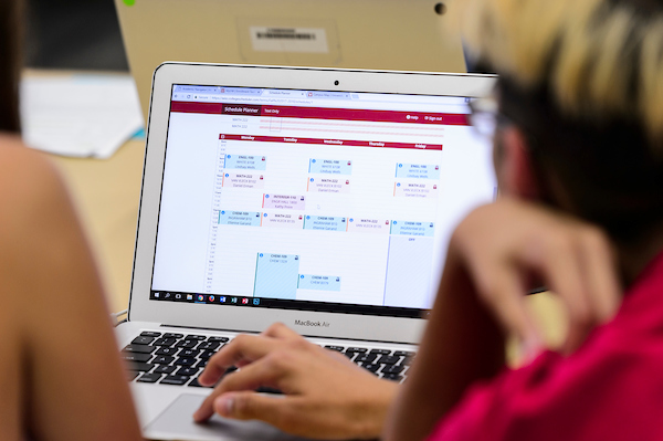 At right, a College of Engineering student-peer advisor works with an incoming first-year undergraduate to register for her classes using a laptop computer during a Student Orientation, Advising and Registration (SOAR) session at College Library in Helen C. White Hall at the University of Wisconsin-Madison on Aug. 9, 2017.