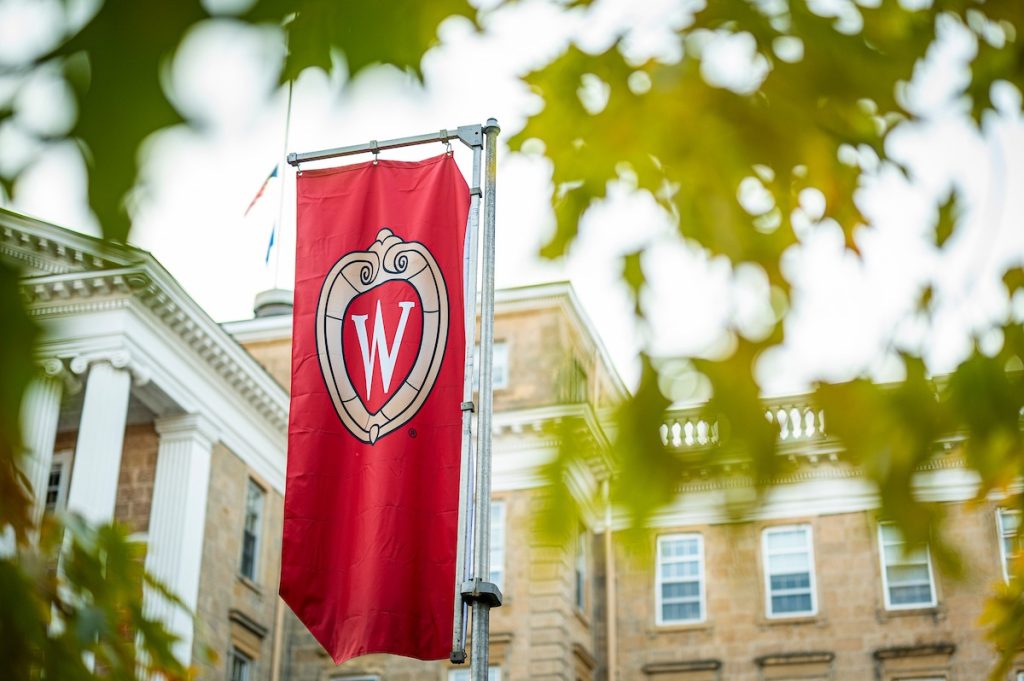 A W crest banner on Bascom Hill is pictured among the colors of the fall leaves at the University of Wisconsin-Madison during autumn on November 8, 2021. (Photo by Bryce Richter / UW-Madison)