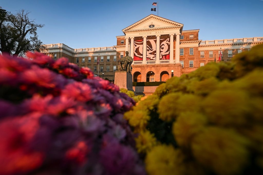 Bascom Hall is touched by the first pink rays of the sun during a fall (autumn) morning at the University of Wisconsin–Madison on Oct. 14, 2024. (Photo by Althea Dotzour / UW–Madison)